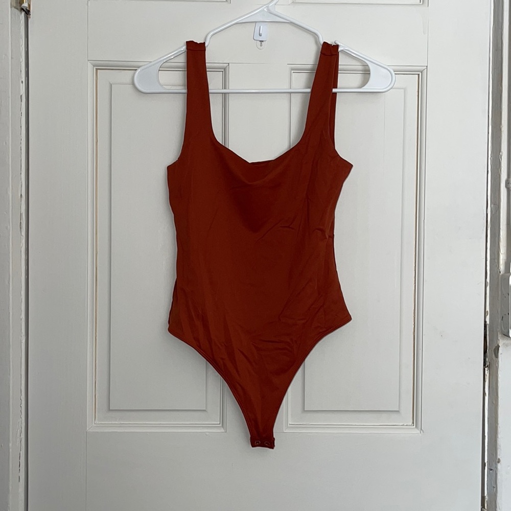 Burnt orange body suit
